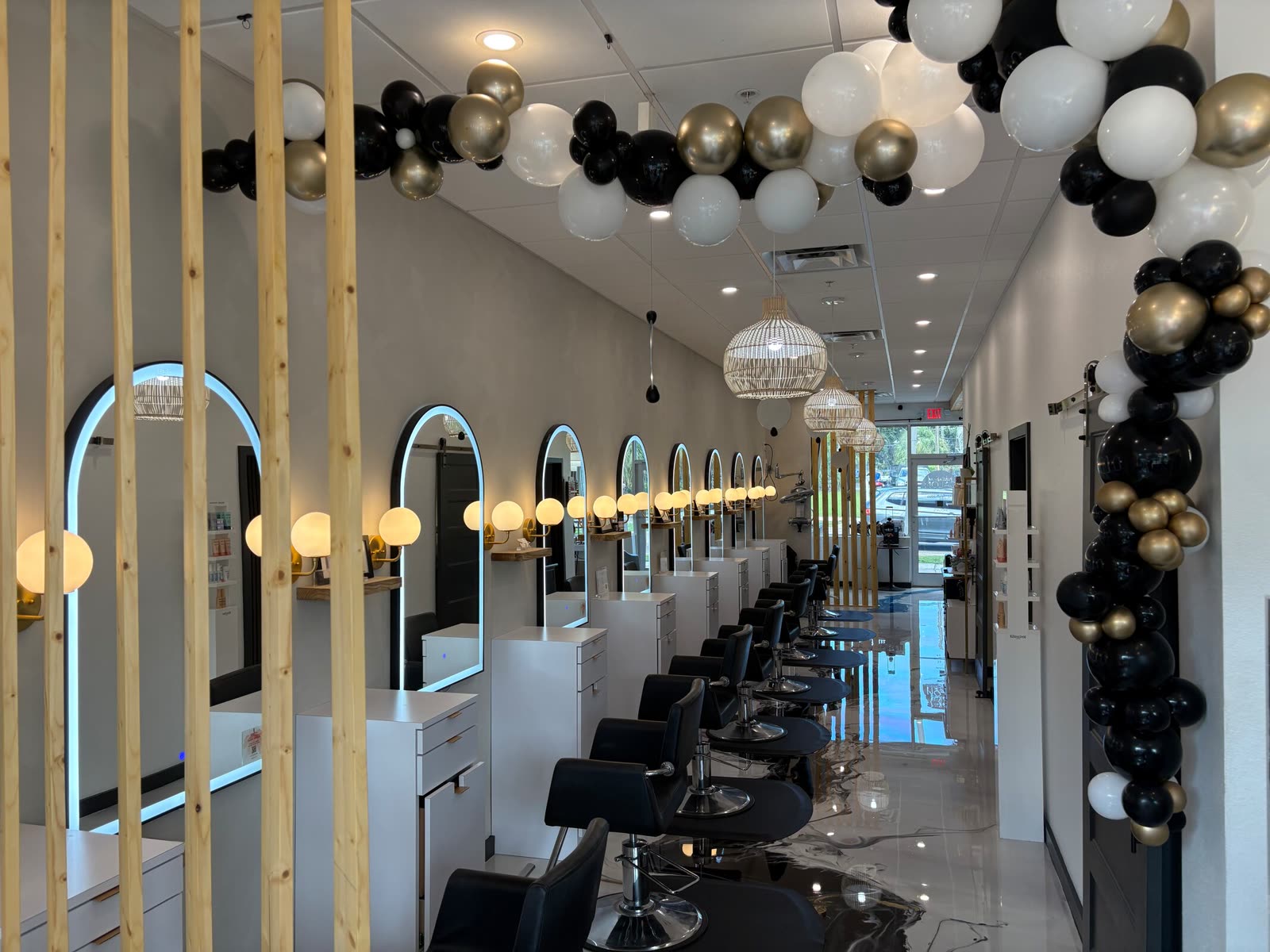White Sand Salon dressed with a black and gold balloon garland for its anniversary celebration